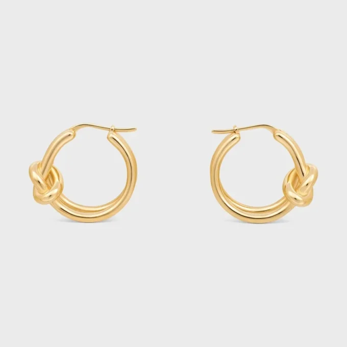 Aros dobles con nudo en latón con acabado dorado Aros dobles con nudo en latón con acabado dorado