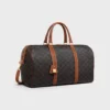 Bolso de viaje mediano en Triomphe Canvas y piel de becerro Bolso de viaje mediano en Triomphe Canvas y piel de becerro