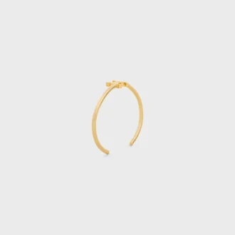 Brazalete asimétrico Triomphe en latón con acabado dorado