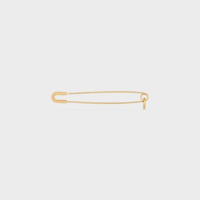 Broche tipo alfiler de seguridad con charms, de latón con acabado dorado Broche tipo alfiler de seguridad con charms, de latón con acabado dorado