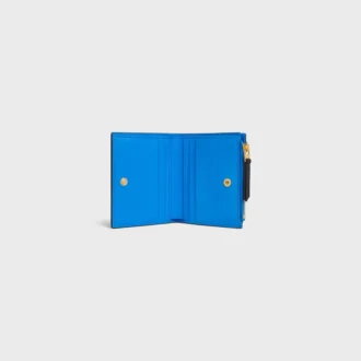 Cartera compacta con estampado Triomphe en piel de becerro granulada y flexible