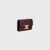 Cartera compacta con monedero Triomphe en piel de becerro brillante