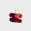 Charm Triomphe con pompón en piel de oveja bordada y piel de becerro