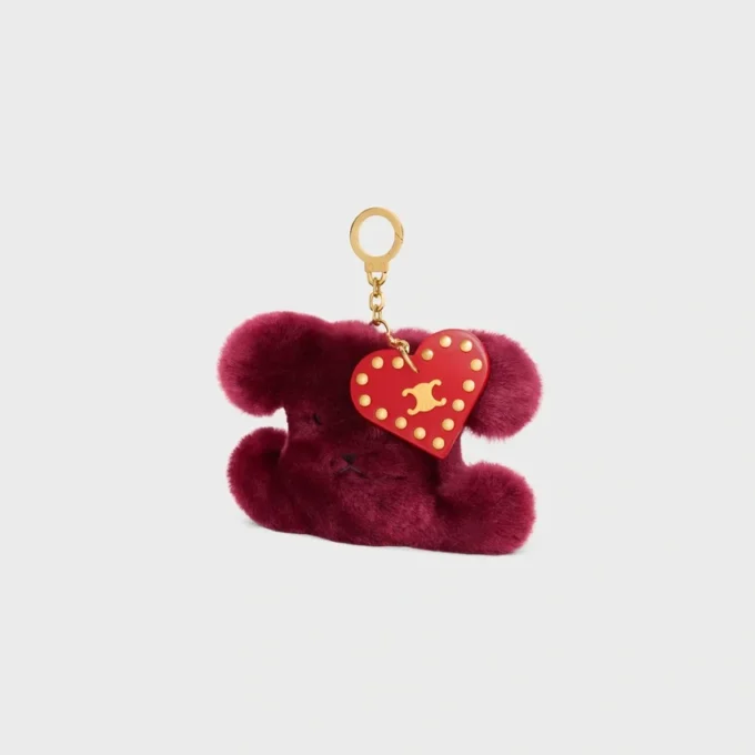 Charm Triomphe con pompón en piel de oveja bordada y piel de becerro