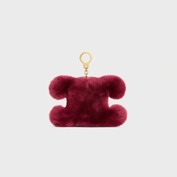 Charm Triomphe con pompón en piel de oveja bordada y piel de becerro