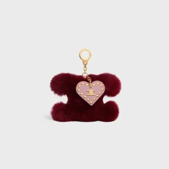 Colgante Triomphe con pompón en piel de oveja y piel de becerro