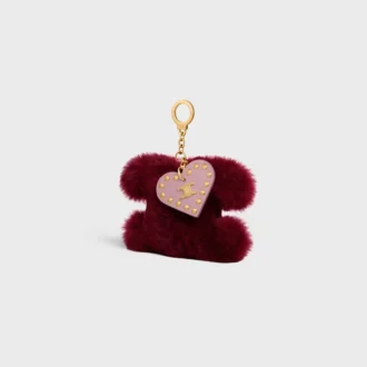 Colgante Triomphe con pompón en piel de oveja y piel de becerro