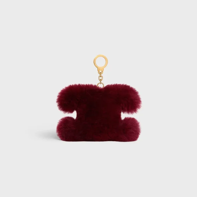 Colgante Triomphe con pompón en piel de oveja y piel de becerro
