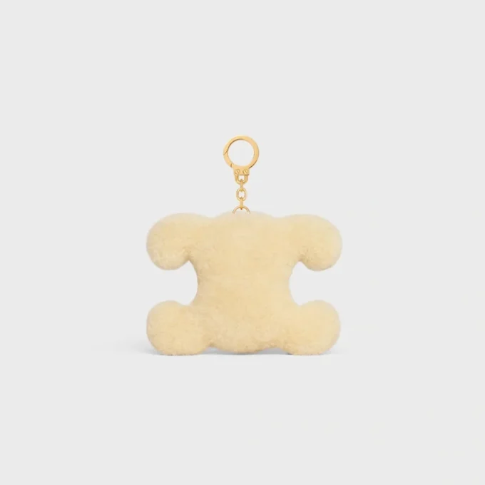 Colgante Triomphe con pompón en piel de oveja y piel de becerro