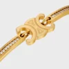 Pulsera articulada Triomphe con brillos, en strass y latón con acabado dorado Pulsera articulada Triomphe con brillos, en strass y latón con acabado dorado