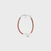 Pulsera con nudo en piel de becerro y latón con acabado de rodio Pulsera con nudo en piel de becerro y latón con acabado de rodio